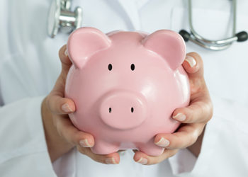 Doctor holding piggy bank - Health Savings Account (HSA)