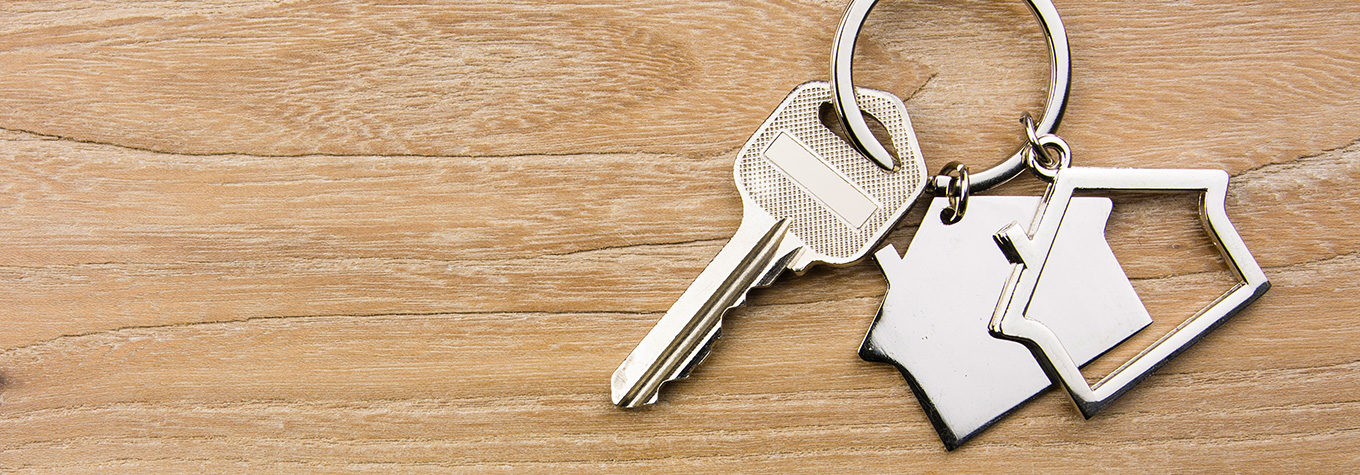 House keys on a wooden table. Unlock the value of your home with a home equity loan from BankWest.